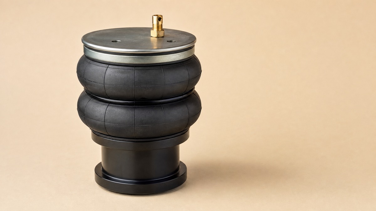 Convoluted air spring with two rubber lobes between a steel plate and a base