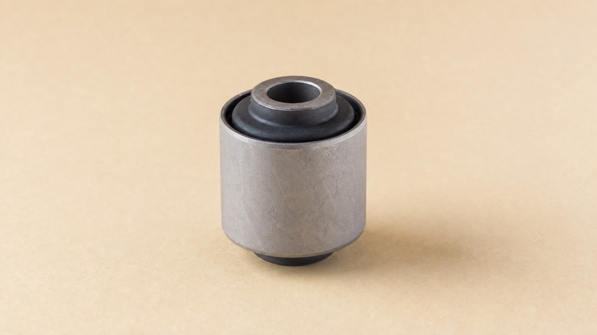 Suspension bushing with a rubber element bonded inside a steel outer shell
